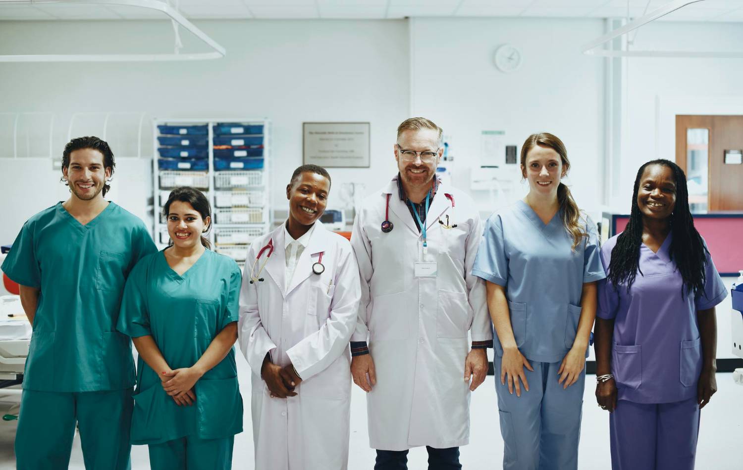 A hospital care team of six clinicians standing together